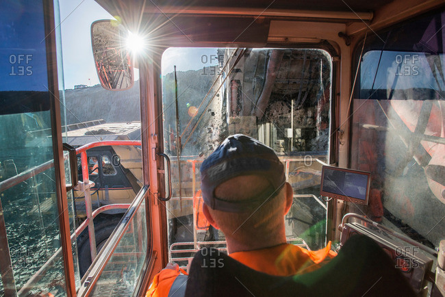 Excavator driver in cab at surface coal mine