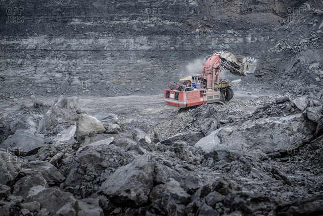 Large excavator and geological strata in surface coal mine