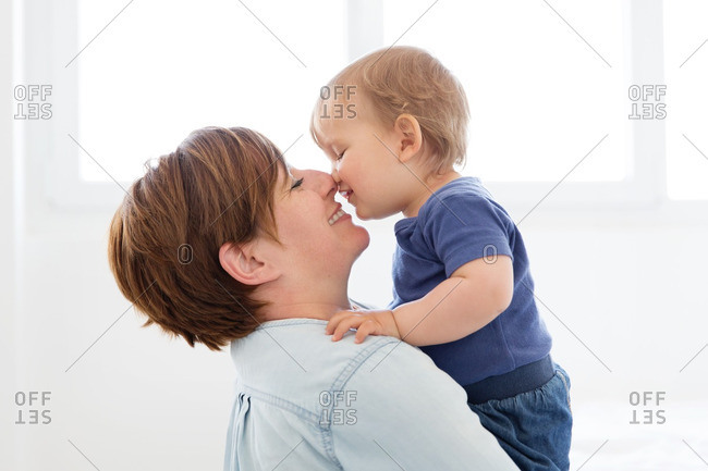 Mother holding baby nose to nose