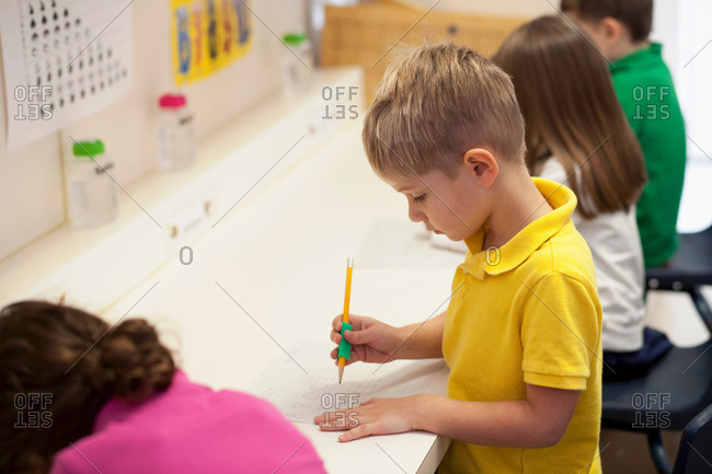 Toddlers writing in classroom