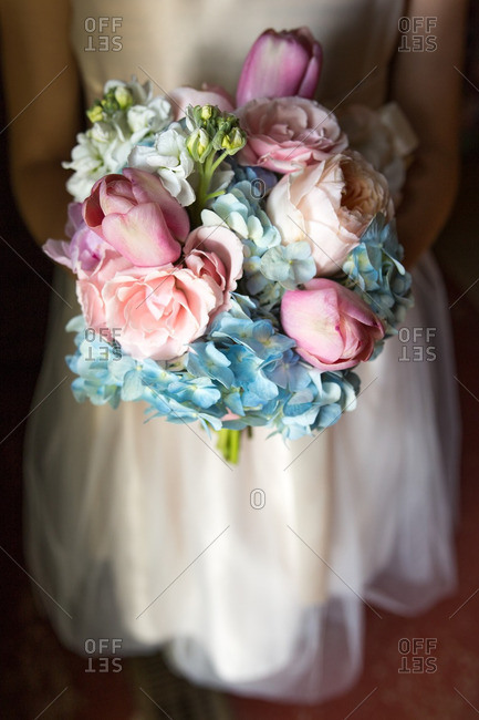 Bride holding a colorful bouquet of hydrangea and tulips