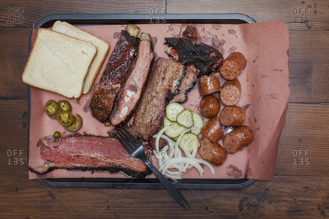 Overhead view of meat served in tray on table