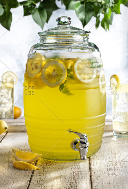 Glass barrel with tap dispenser containing fresh lemonade drink
