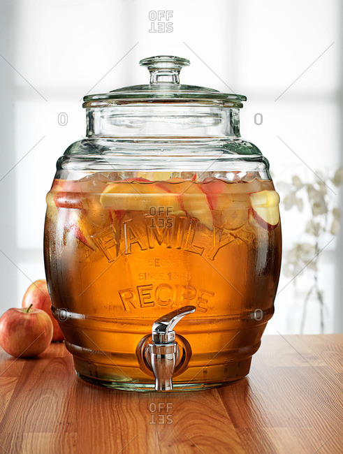 Glass barrel with tap dispenser containing fresh apple drink