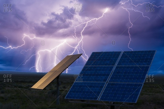 Composite of solar panels, photovoltaic solar array in lightning and thunderstorm