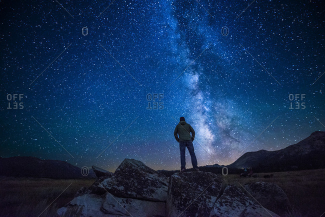 Man standing beneath a starry night sky in Hope Valley near Lake Tahoe, California