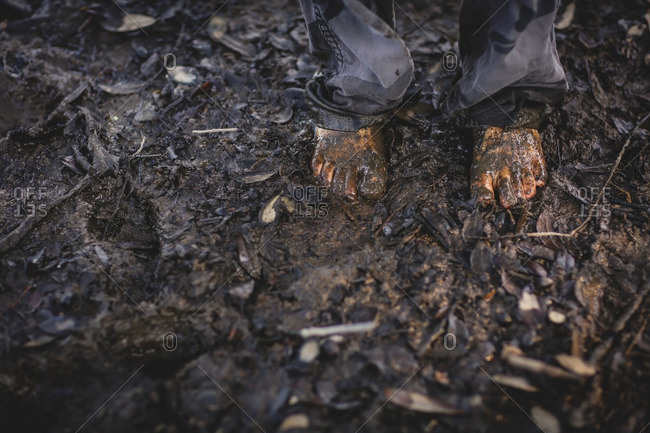 Child\'s bare feet in mud