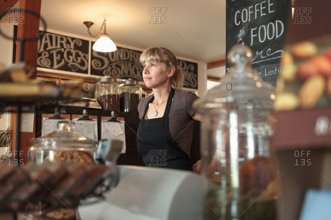 Female shop assistant in country store cafe