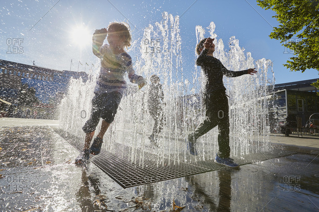 Boys playing in city fountain