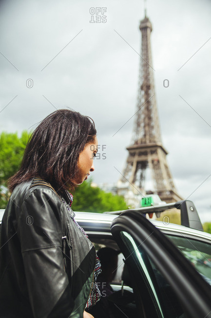 Young woman entering a taxi