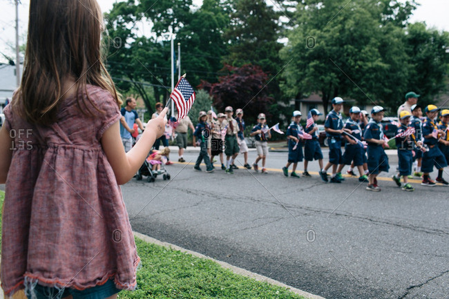 Girl waving American flag at a parade