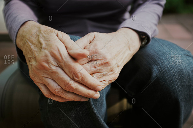 Senior woman with hands on knee