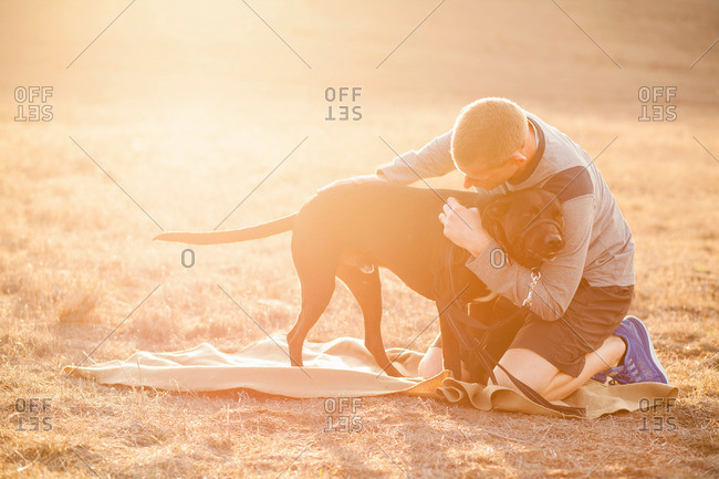 Man hugging dog