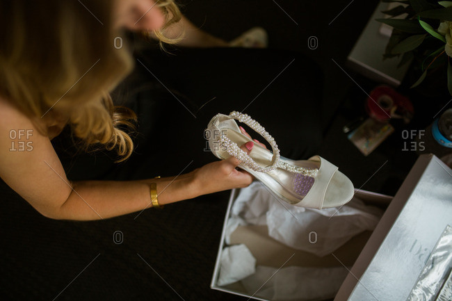 Woman getting bridal shoes out of box