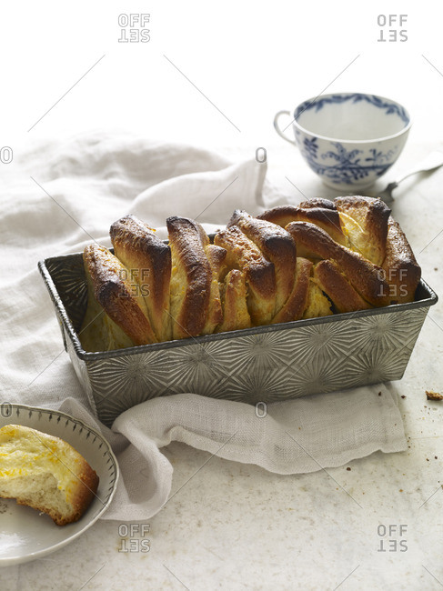 Pull-apart bread in a metal baking tin and on a plate