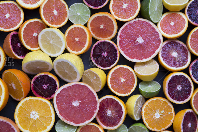 Variety of halved citrus fruits