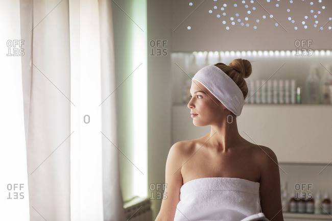 Thoughtful woman sitting at health spa