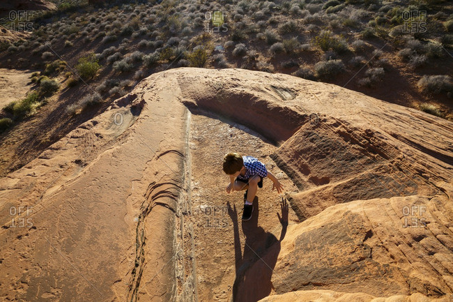Overhead view of boy sitting on rock at Valley of Fire State Park
