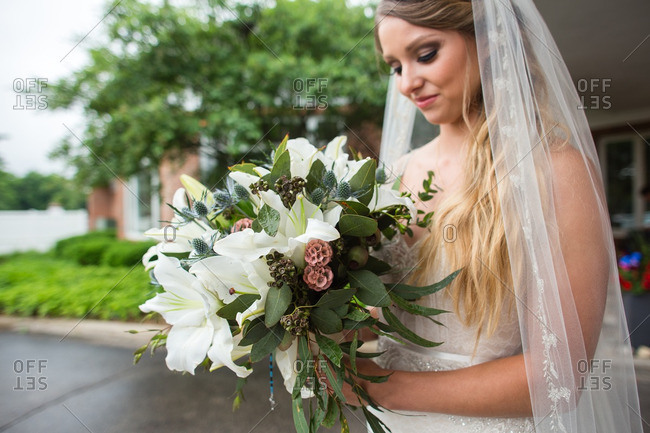 A bride looking at her bouquet