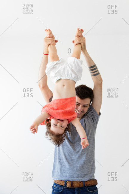 Father holding his daughter upside down