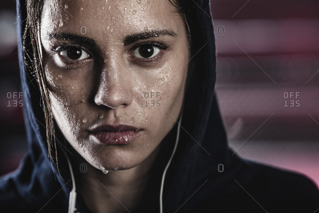 Close-up portrait of young woman with sweat on face