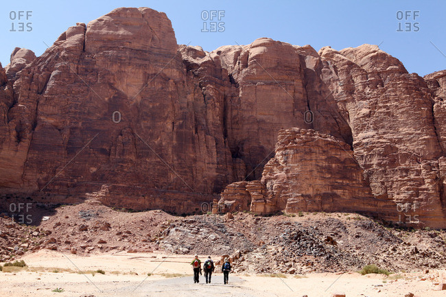 Three hikers hiking in Wadi Rum, Jordan