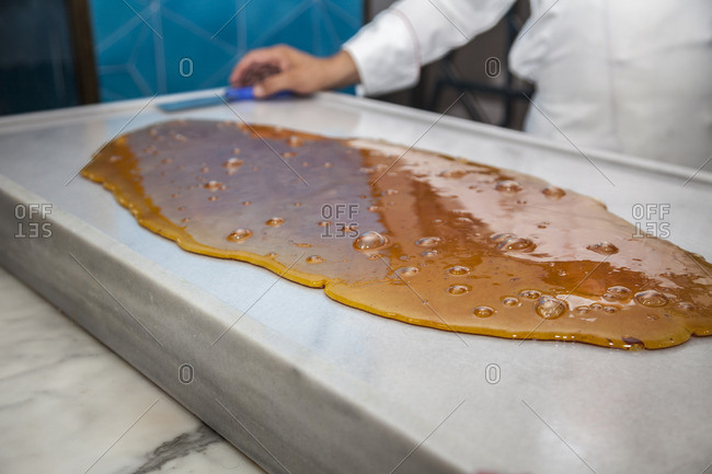 A molten candy mix is prepared by a candy maker in an upscale restaurant in Istanbul, Turkey