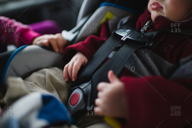 Close-up of a baby boy buckled up in a car seat