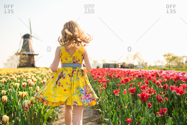 Girl walking among tulips