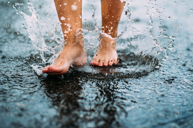 Feet splashing in a puddle