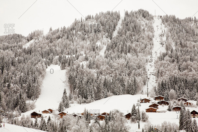 Houses and chairlift on snowy mountain