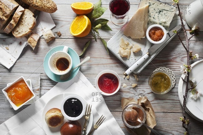 Various types of jam and jellies with cheese and bread