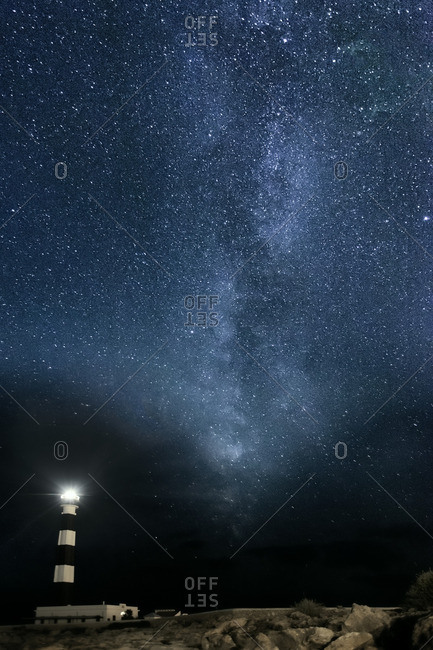 A lighthouse under Milky Way