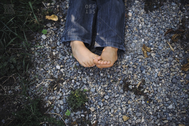 Child\'s bare feet on pebbles