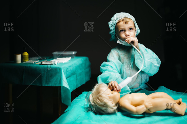 Young doctor healing a doll
