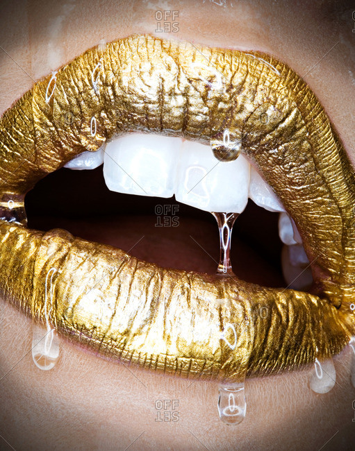 Golden lips dripping with water