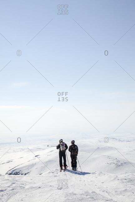 Sweden, Jamtland, Snasahogarna, Rear view of mid-adult men looking at mountains in winter