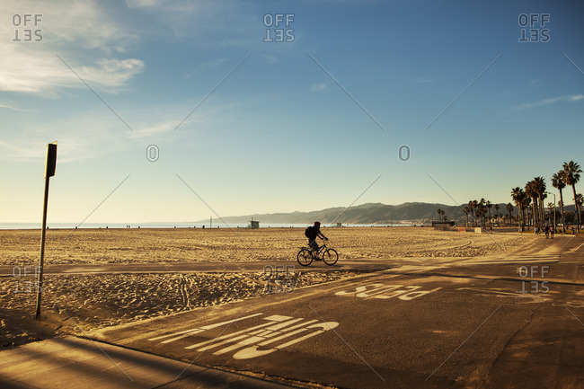 USA, California, Los Angeles, Venice Beach, One person cycling along beach