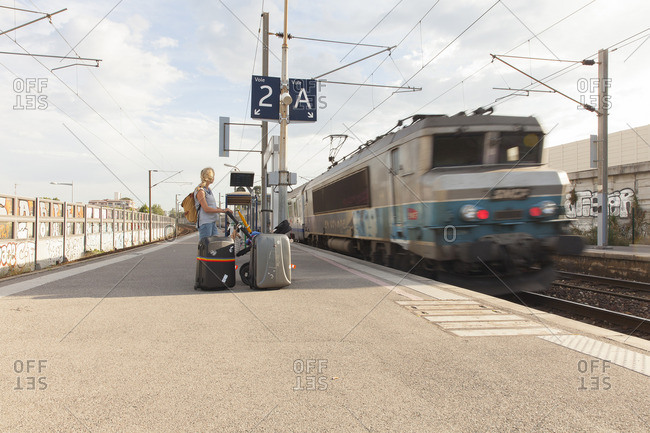 France, Nice, Woman with baby on railroad station platform