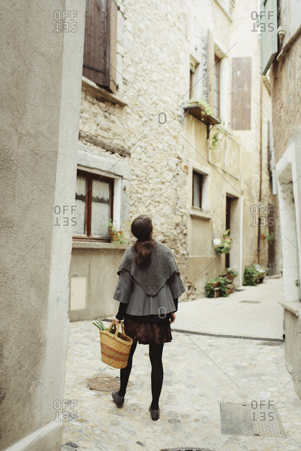 France, Languedoc-Roussillon, Sauve, Young woman walking in old town