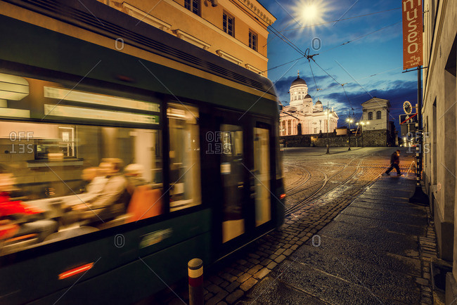 Finland, Helsinki, Kronohagen, Cable car at night, Helsinki Lutheran Cathedral in background