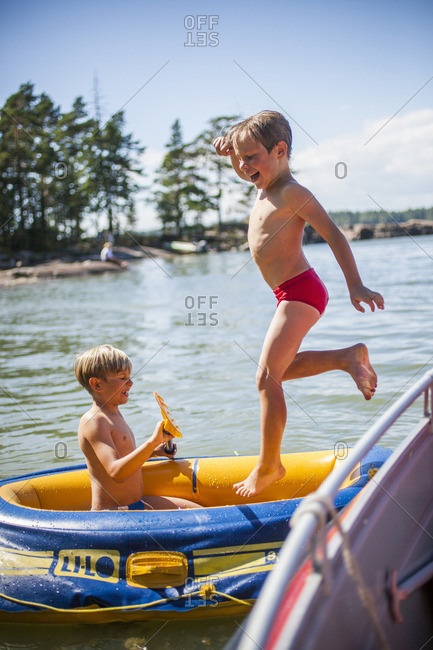 Finland, Paiijat-Hame, Konnivesi, Boys playing in inflatable raft
