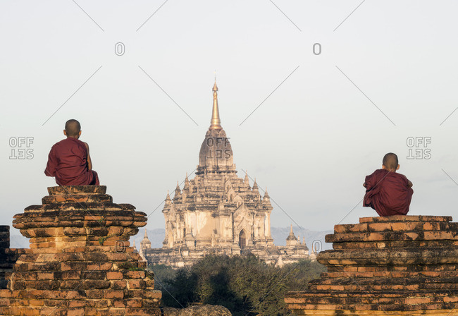 Two young Buddhist monks overlooking ancient temples in Bagan, Myanmar