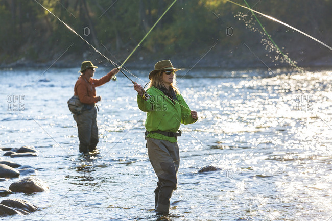 Couple fly fishing in river