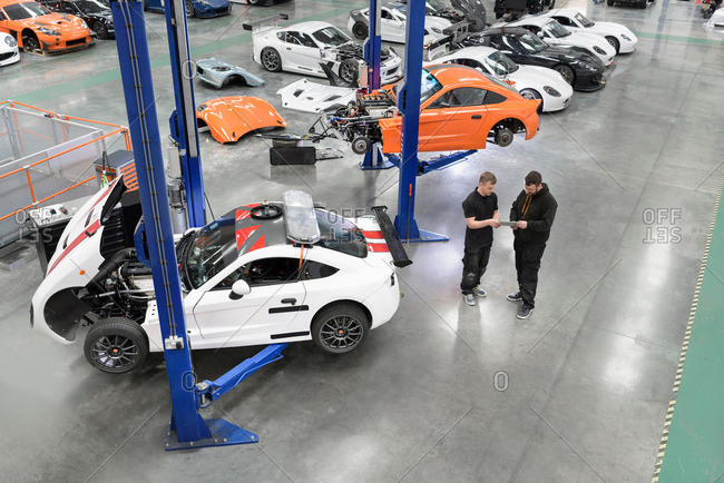 Garforth, UK - May 10, 2016: Engineer repairing racing cars in racing car factory