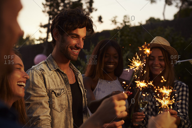Group Of Friends With Sparklers Enjoying Outdoor Party