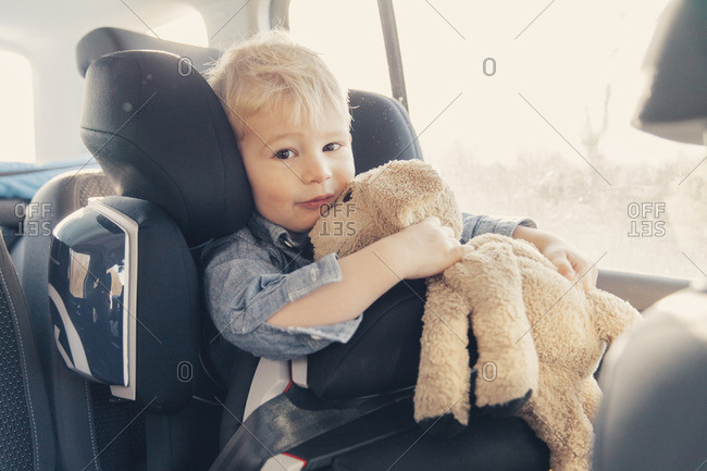 Germany- Little boy sitting in back-seat car seat