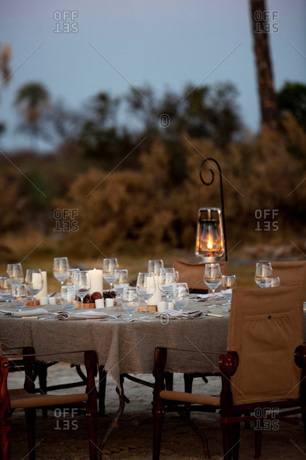 A dinner table is set in the bush at Abu Camp, a luxury safari camp in the Okavango Delta, Botswana
