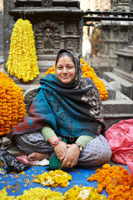 Portrait of female street trader with flower garlands, Thamel, Kathmandu, Nepal