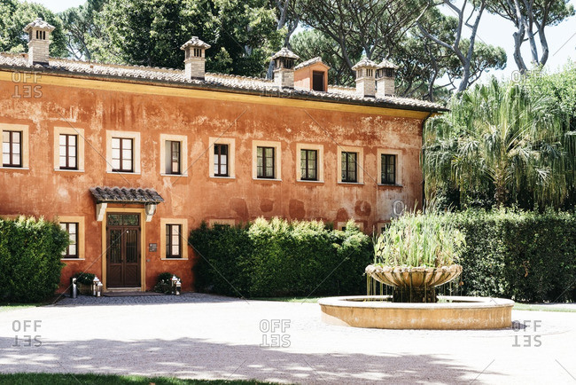 Italian villa with fountain in sunlight